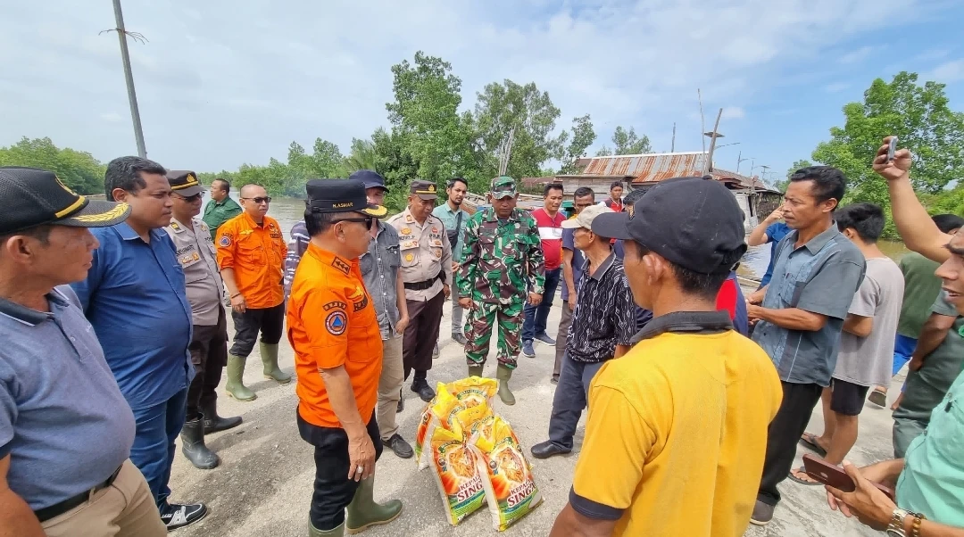 Memberikan bantuan untuk warga terdampak banjir di pulau merbau